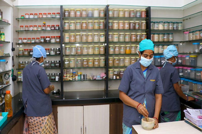 Staff preparing classical Ayurvedic medicines in Netrayu's pharmacy